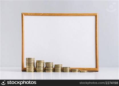 increasing stacked coins front blank white board reflective desk