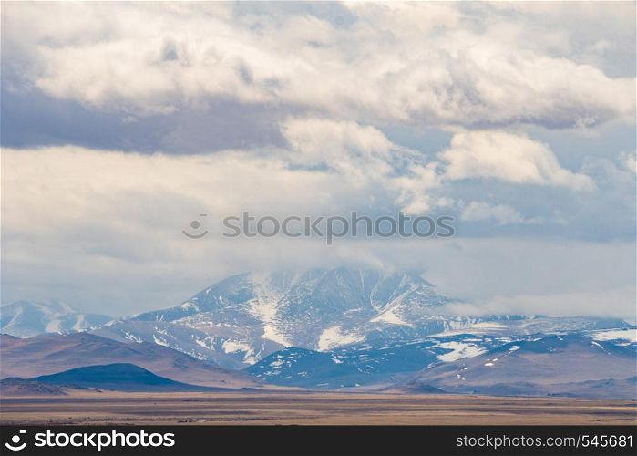 incredible landscape of the peaks of Altai mountains on the background of floating clouds.. incredible landscape of the peaks of Altai mountains on the background of floating clouds
