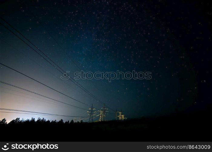 Incredible night sky with stars, Milky Way passing over power line in long exposure timelapse. Beautiful panorama view. Nature in the countryside. Astro photography.. Incredible night sky with stars, Milky Way passing over power line in long exposure timelapse. Beautiful panorama view. Nature in the countryside. Astro photography
