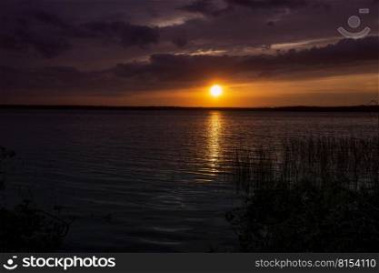 Incredibly beautiful sunset on the lake. High quality photo. Incredibly beautiful sunset on the lake