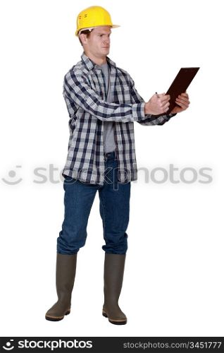 Incredulous tradesman looking at a clipboard