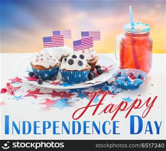 independence day, celebration, patriotism and holidays concept - close up of cupcakes or muffins decorated with american flags, candies and lemonade drink in mason jar at party 4th of july. cupcakes with american flags on independence day. cupcakes with american flags on independence day