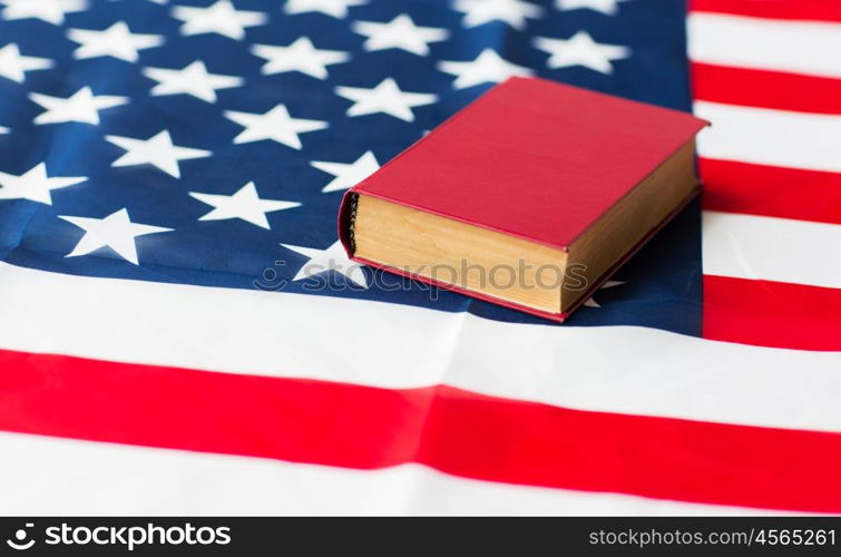 independence day, patriotism, civil rights, cultural values and nationalism concept - close up of american flag and constitution book or bible