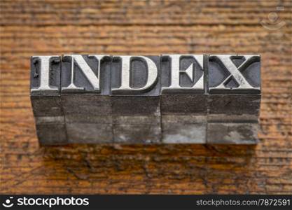 index word in mixed vintage metal type printing blocks over grunge wood