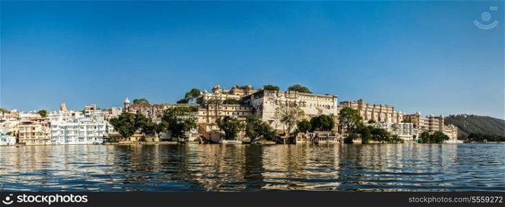 India luxury tourism concept background - panorama of Udaipur City Palace from Lake Pichola. Udaipur, India