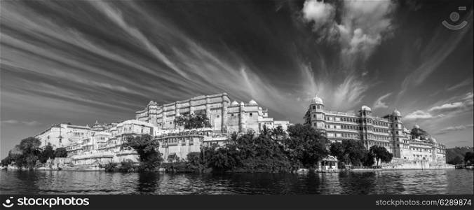 India luxury tourism concept background - panorama of Udaipur City Palace from Lake Pichola. Udaipur, India. Black and white version