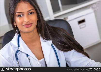 Indian Asian female medical doctor in a hospital office happy and smiling with stethoscope