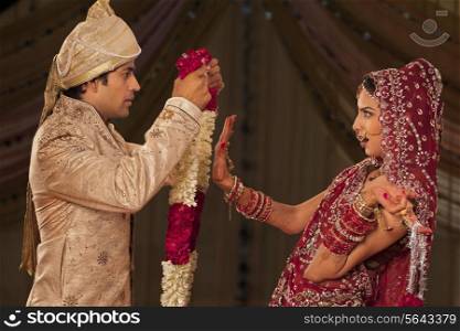 Indian bride rejecting a groom with a garland