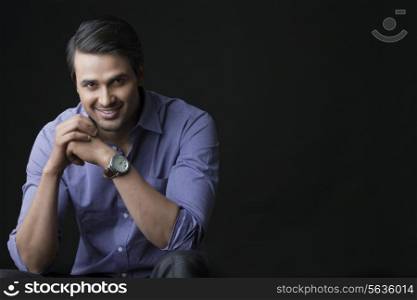 Indian businessman smiling isolated over black background