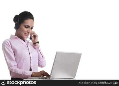 Indian businesswoman using headset and laptop isolated on white background