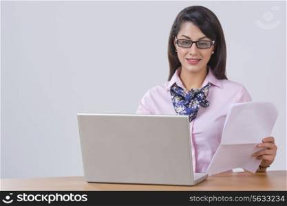 Indian businesswoman working on laptop at desk in office