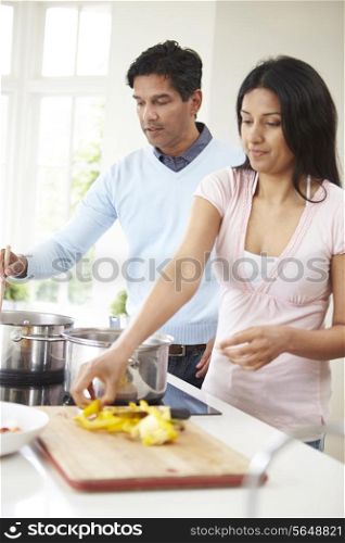 Indian Couple Cooking Meal At Home