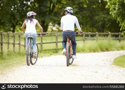 Indian Couple On Cycle Ride In Countryside