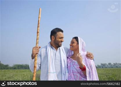 Indian couple smiling while looking at each other