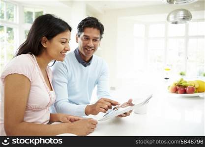 Indian Couple Using Digital Tablet At Home