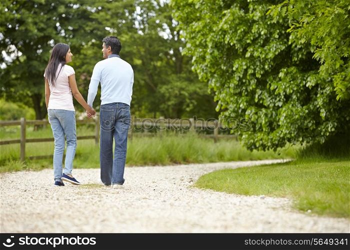 Indian Couple Walking In Countryside
