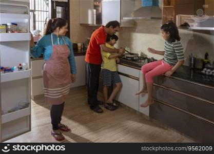 Indian family members cooking food in the kitchen