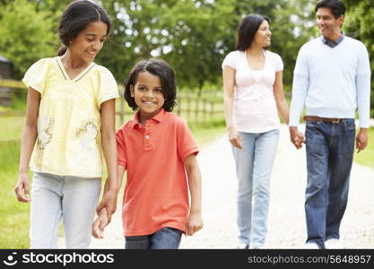 Indian Family Walking In Countryside