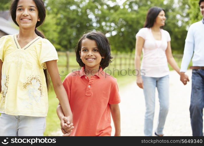 Indian Family Walking In Countryside