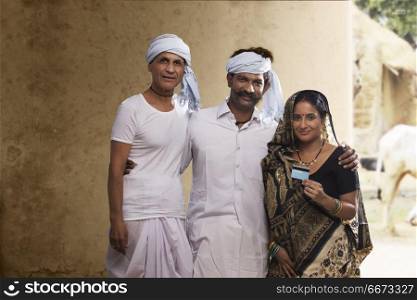 Indian farmer family holding credit card