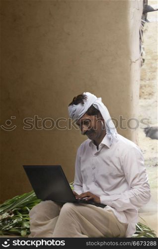 Indian farmer using laptop