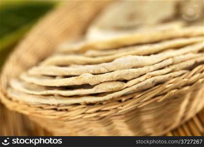Indian flatbread called chapati in basket (Selective Focus, Focus on the front edge of the first three chapati). Chapatis