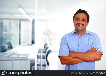 Indian latin businessman blue shirt in modern office background