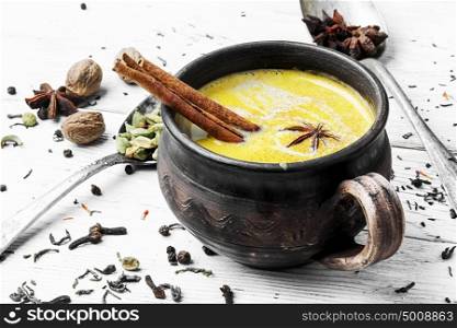 Indian masala tea. Masala tea in rustic clay mug with spices on light background