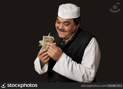Indian politician taking bribes over black background