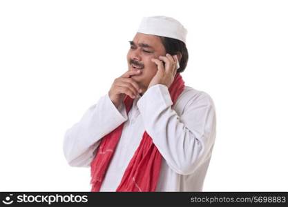 Indian politician thinking while talking on mobile phone