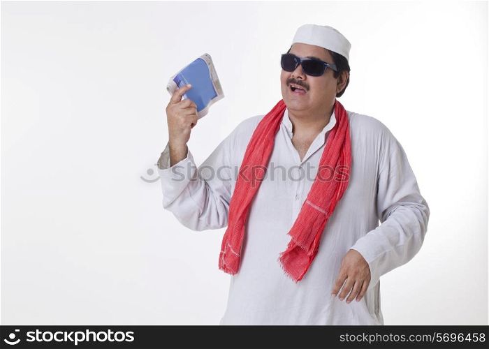 Indian politician with paper fan