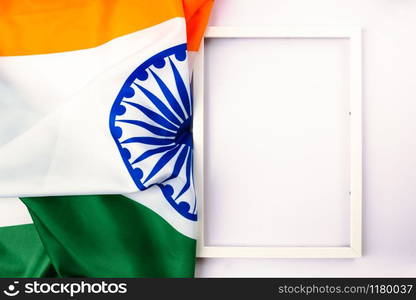 Indian republic day, flat lay top view, Indian tricolor flag and photo frame on white background with copy space for your text