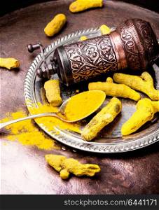 indian roots turmeric. Turmeric powder and root turmeric in a bowl