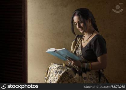Indian rural woman reading book