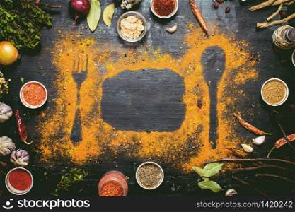 Indian spices and herbs. Print of ground spices on the table. On the black chalkboard.. Indian spices and herbs.