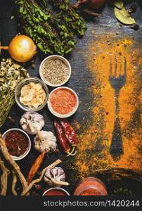 Indian spices and herbs. Print of ground spices on the table. On the black chalkboard.. Indian spices and herbs.