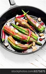 Indian spicy food from baked okra with spices.Vegetarianism. Vegetarian dish from okra