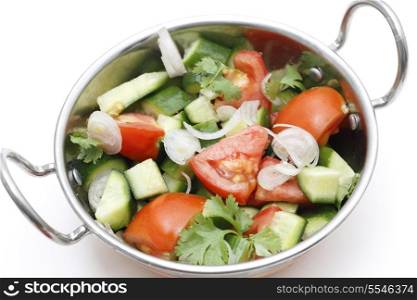 Indian tomato, cucumber and sliced shallot salad served in a Kadai bowl