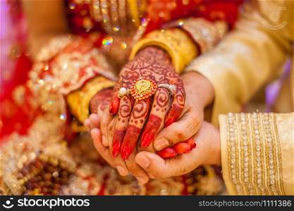 Indian wedding hands with gold. Indian wedding hands