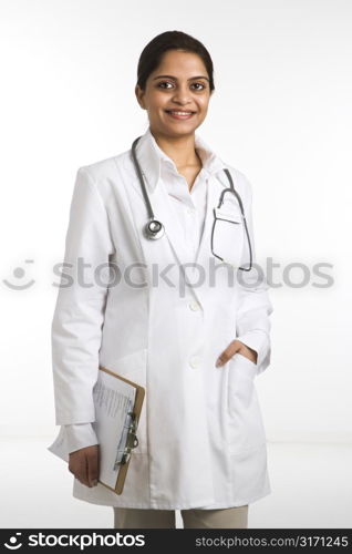 Indian woman doctor portrait standing against white background.
