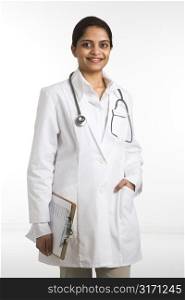 Indian woman doctor portrait standing against white background.