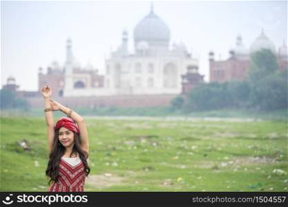 Indian woman in red saree/sari in the Taj Mahal, Agra, Uttar Pradesh, India