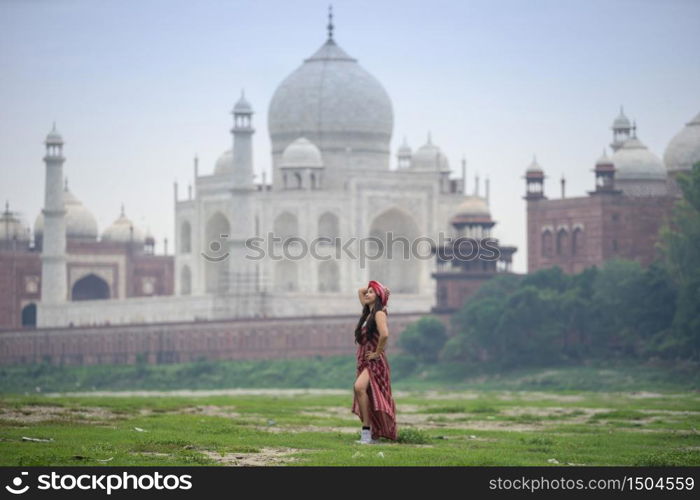 Indian woman in red saree/sari in the Taj Mahal, Agra, Uttar Pradesh, India