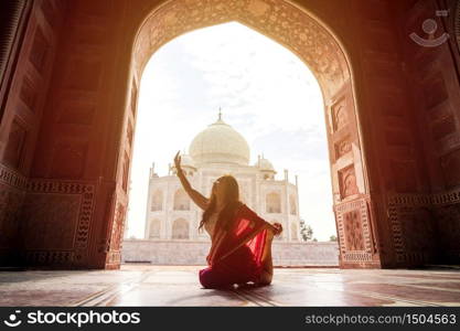 Indian woman in red saree/sari in the Taj Mahal, Agra, Uttar Pradesh, India