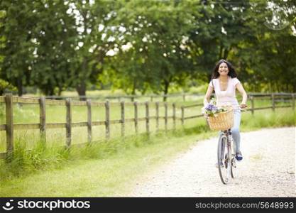 Indian Woman On Cycle Ride In Countryside