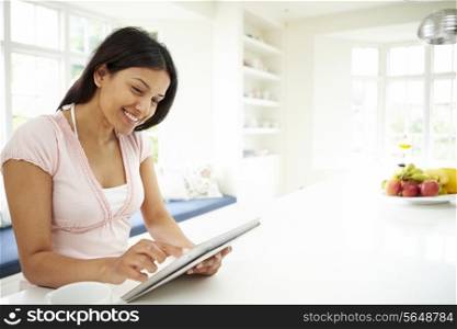 Indian Woman Using Digital Tablet At Home