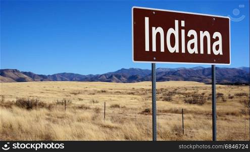 Indiana road sign with blue sky and wilderness. Indiana brown road sign