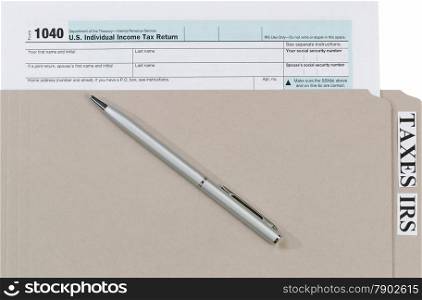 Individual income tax form inside of gray folder with pen. Business financial concept for taxes.