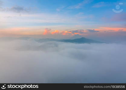 Indonesia. Bromo Tengger Semeru National Park. A thick fog at dawn with a view to the Semeru. Thick Fog between the Mountain Peaks at Dawn