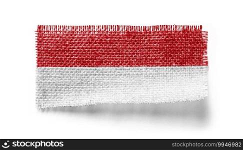 Indonesia flag on a piece of cloth on a white background.. Indonesia flag on a piece of cloth on a white background